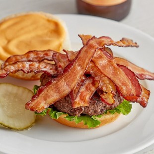 Swift Fully Cooked Thick Bacon Slices - 240/Case Swift Fully Cooked Thick Bacon Slices - 240/Case