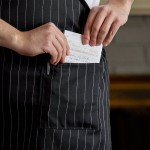 Choice Black and White Pinstripe Poly-Cotton Standard Bib Apron with 2 Pockets - 34