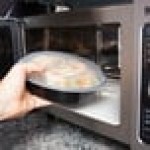 Pactiv Newspring NC737B 35 oz. Black VERSAtainer Round Microwavable Container with Lid - 150/Case