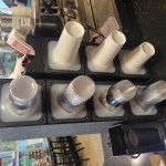 KleanTake by ServSense Black Countertop Slim Cup Dispenser Cabinet with 6 Fast-Changing Gaskets - 4 Slot