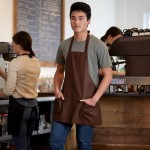 Choice Brown Poly-Cotton Front of House Bib Apron with 3 Pockets - 25 Choice Brown Poly-Cotton Front of House Bib Apron with 3 Pockets - 25