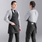 Uncommon Chef 3042 Black Customizable Poly-Cotton Twill Scoop Neck Tuxedo Apron with Adjustable Neck Strap and 3 Pockets - 28