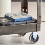 Lavex Medium Black 2-Shelf Utility Cart with Premium Handle and Built-In Tool Compartments - 40 11/16