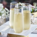Visions Dynasty 9 oz. Clear Plastic Stemless Champagne Flute with Gold Rim - 64/Case Visions Dynasty 9 oz. Clear Plastic Stemless Champagne Flute with Gold Rim - 64/Case