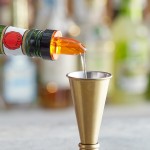 Choice Short Free Flow Amber Liquor Pourer with Collar - 12/Pack Choice Short Free Flow Amber Liquor Pourer with Collar - 12/Pack