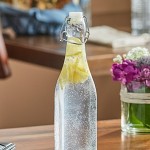 Acopa 19 oz. Customizable Clear Glass Bottle with Wire Bail Swing Top Lid - 12/Case