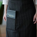 Choice Black and White Pinstripe Poly-Cotton Standard Bistro Apron with 1 Pocket - 33