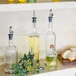 TableCraft 17.5 oz. Clear Glass Oil and Vinegar Bottle with Weighted Stainless Steel Pourer - 12/Case TableCraft 17.5 oz. Clear Glass Oil and Vinegar Bottle with Weighted Stainless Steel Pourer - 12/Case