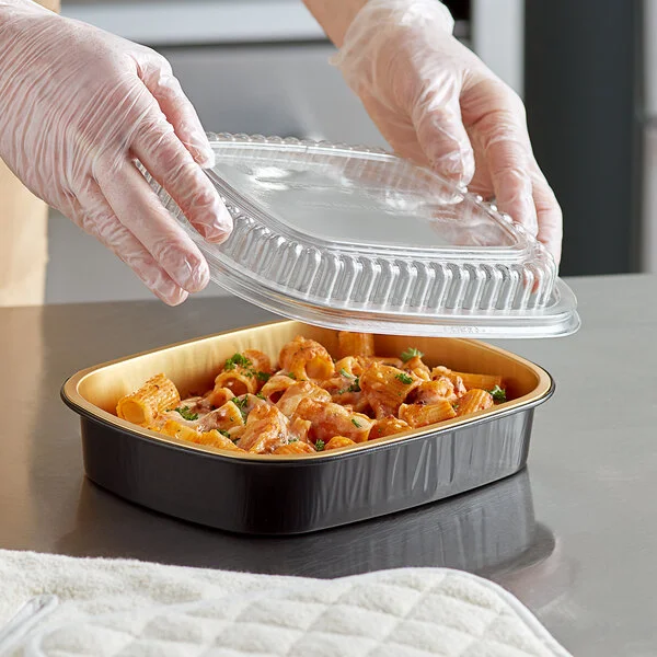 Choice Heavy Duty Smoothwall Black and Gold Medium Oblong Foil Entree / Take-Out Pan with Dome Lid 47.4 oz. - 10/Pack