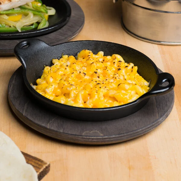 Lodge 14 oz. Pre-Seasoned Heat-Treated Mini Cast Iron Round Casserole Dish with Walnut Wood Underliner Lodge 14 oz. Pre-Seasoned Heat-Treated Mini Cast Iron Round Casserole Dish with Walnut Wood Underliner