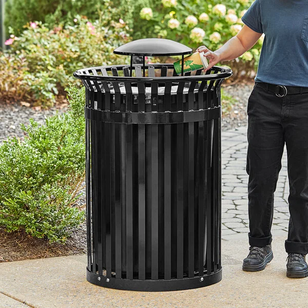 Lancaster Table & Seating 45 Gallon Heavy-Duty Round Black Steel Slatted Outdoor Trash Can with Rain Bonnet Lid Lancaster Table & Seating 45 Gallon Heavy-Duty Round Black Steel Slatted Outdoor Trash Can with Rain Bonnet Lid