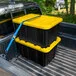 Sterilite 27 Gallon Black Industrial Storage Tote with Yellow Lily Lid 50659Y06 - 6/Case Sterilite 27 Gallon Black Industrial Storage Tote with Yellow Lily Lid 50659Y06 - 6/Case