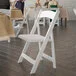 Flash Furniture Hercules White Wood Folding Chair with White Vinyl Seat - 2/Case Flash Furniture Hercules White Wood Folding Chair with White Vinyl Seat - 2/Case