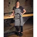 Mercer Culinary M63205GRY Metro Edge Odin Gray Chambray Bib Apron with Adjustable Neck, Black Webbing, and 1 Pocket - 32 Mercer Culinary M63205GRY Metro Edge Odin Gray Chambray Bib Apron with Adjustable Neck, Black Webbing, and 1 Pocket - 32