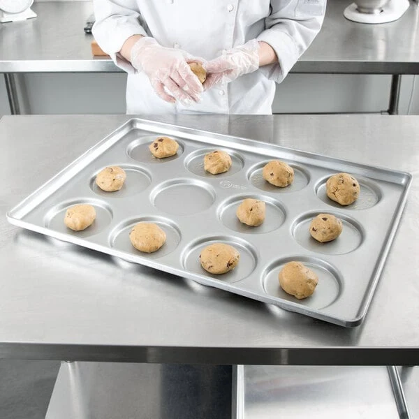 Chicago Metallic 41005 Glazed Aluminized Steel 12 Mold 5.09 oz. Individual Hamburger Bun / Muffin Top / Cookie Pan - 17 3/4
